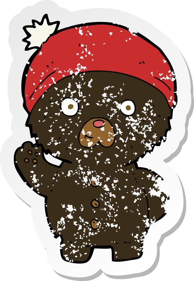 adesivo retrò in difficoltà di un cartone animato che sventola un orsacchiotto nero con un cappello invernale vettore