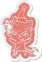 simpatico cartone animato adesivo in difficoltà di un gatto che indossa il cappello di Babbo Natale vettore