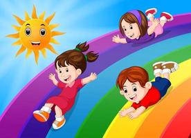 bambini che scivolano sull'arcobaleno nel cielo vettore
