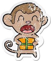 adesivo angosciato di una scimmia cartone animato urlante che porta il regalo di Natale vettore