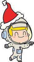 felice disegno di un uomo astronauta che indossa il cappello di Babbo Natale vettore