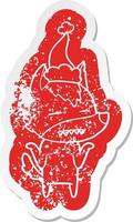 adesivo in difficoltà cartone animato di un lupo che mostra i denti che indossano il cappello di Babbo Natale vettore