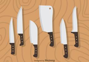 Set di coltelli su legno vettoriale