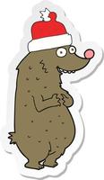 adesivo di un orso cartone animato che indossa il cappello di Natale vettore