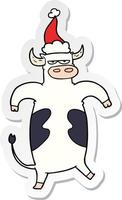 cartone animato adesivo di un toro che indossa il cappello di Babbo Natale vettore