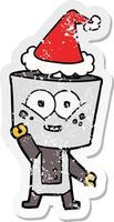 felice cartone animato adesivo angosciato di un robot che saluta con un cappello da Babbo Natale vettore
