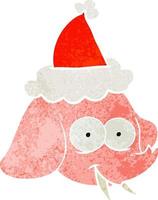 cartone animato retrò di una faccia di elefante che indossa il cappello di Babbo Natale vettore