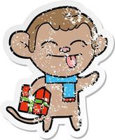 adesivo in difficoltà di una scimmia divertente cartone animato con regalo di Natale vettore
