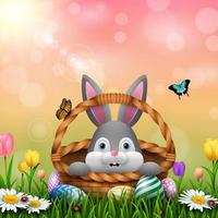 carino Pasqua coniglietto nel un' cestino con colorato uova su il erba vettore