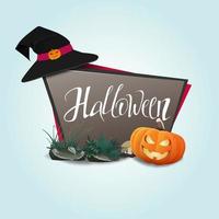 banner di halloween con zucche e un cappello da strega vettore