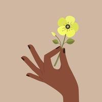 mano nera che tiene fiore giallo vettore