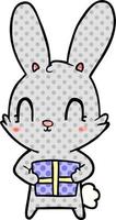 carino cartone animato coniglio con presente vettore