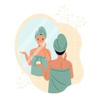 un' donna nel un' asciugamano e un' turbante nel il bagno nel davanti di un' specchio si applica crema per sua viso. bellezza e pelle cura concetto. vettore azione illustrazione.