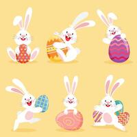 set di conigli pasquali con uova decorate vettore