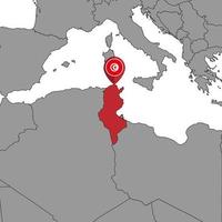 mappa pin con bandiera tunisia sulla mappa del mondo. illustrazione vettoriale. vettore