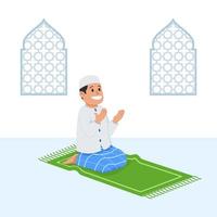 ragazzo musulmano si siede e prega sul tappetino di preghiera vettore