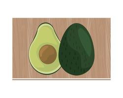 mezzo avocado sul bordo della cucina in legno vettore