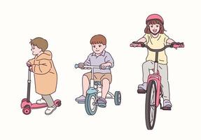 bambini carini che vanno in bicicletta. vettore
