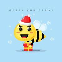 simpatica mascotte delle api porta una confezione regalo il giorno di Natale vettore