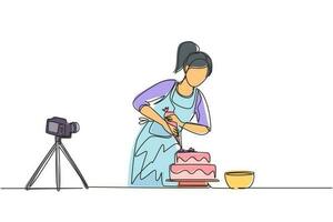 ragazza di disegno a linea continua singola che cuoce e decora la torta in cucina. blogger donna che registra video sulla fotocamera, usando il treppiede, pubblicandolo sui social media. illustrazione vettoriale di un disegno di linea