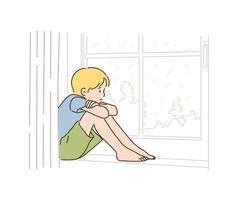 un ragazzo è seduto vicino alla finestra e guarda la pioggia. illustrazioni di disegno vettoriale stile disegnato a mano.