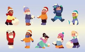 simpatici bambini in gruppo giocano a neve con vestiti caldi vettore