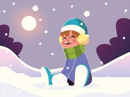 ragazzo felice con vestiti caldi seduto nella neve che gioca vettore