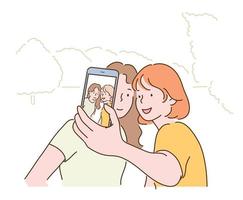 due amici stanno facendo un selfie con i loro telefoni cellulari. illustrazioni di disegno vettoriale stile disegnato a mano.
