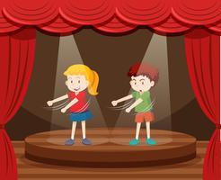 Due bambini che ballano sul palco vettore