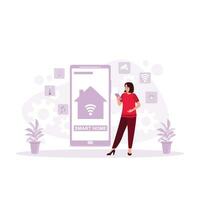 giovane donna utilizzando il inteligente casa App su sua Telefono schermo. inteligente casa concetto. tendenza moderno vettore piatto illustrazione