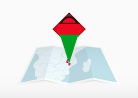 malawi è raffigurato su un' piegato carta carta geografica e appuntato Posizione marcatore con bandiera di Malawi. vettore