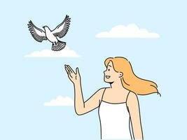 donna rilasci colomba in piedi sotto estate blu cielo e Guardando uccello simboleggiare speranza e pace vettore