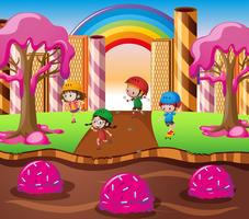 Bambini felici che giocano in terra delle caramelle vettore