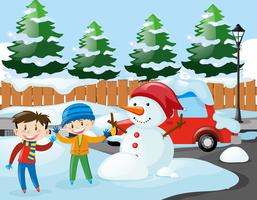 Due ragazzi e un pupazzo di neve sulla strada vettore