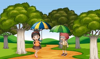 Due bambini con l&#39;ombrello nel parco vettore