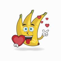 personaggio mascotte banana che tiene un'icona d'amore. illustrazione vettoriale