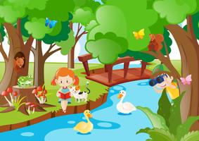 Bambini e animali vicino al fiume vettore