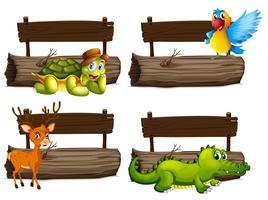 Segni di legno con molti animali vettore