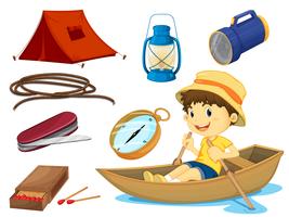 un ragazzo e vari oggetti di campeggio vettore