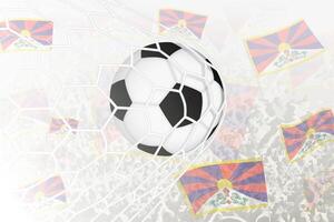 nazionale calcio squadra di Tibet segnato obiettivo. palla nel obbiettivo rete, mentre calcio sostenitori siamo agitando il Tibet bandiera nel il sfondo. vettore