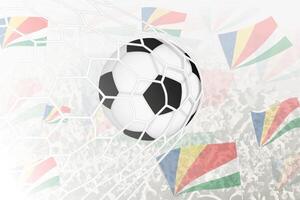 nazionale calcio squadra di Seychelles segnato obiettivo. palla nel obbiettivo rete, mentre calcio sostenitori siamo agitando il Seychelles bandiera nel il sfondo. vettore
