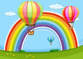 Palloncini colorati che sorvolano l&#39;arcobaleno vettore