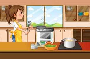 Donna che cucina in cucina vettore