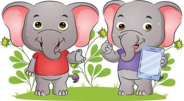 la coppia elefante spiega e tiene in mano un tablet con l'espressione felice vettore