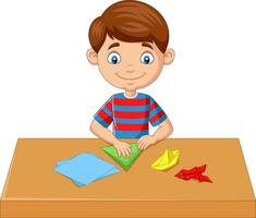 ragazzino che piega la carta e fa giocattoli di origami vettore