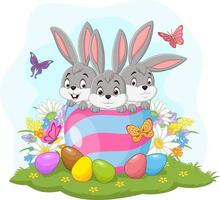 tre coniglietti pasquali nell'uovo di Pasqua vettore