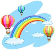 Tre palloncini che sorvolano l&#39;arcobaleno vettore