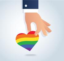 mano che tiene il vettore di cuore bandiera arcobaleno. L&#39;amore è amore, l&#39;amore vince