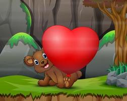 orsetto felice con palloncino cuore rosso in natura vettore
