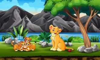 famiglia di leoni che gioca nella giungla vettore